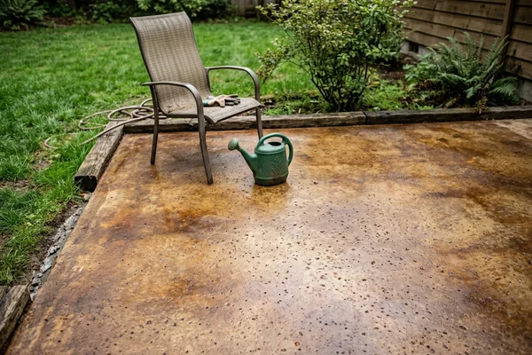 Acid-stained concrete patio in warm brown tones after resurfacing