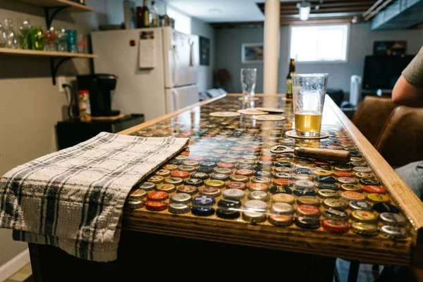 Bottlecaps embedded under clear cast resin in a home bar countertop