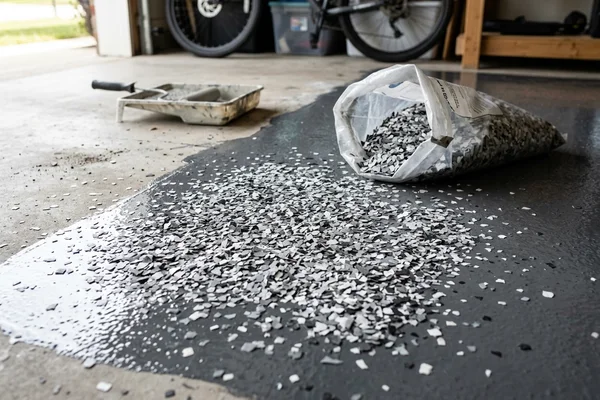 Decorative vinyl flake broadcast into a wet epoxy basecoat