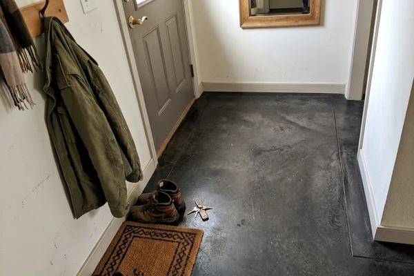 Finished stained concrete entryway in charcoal with a satin sealer