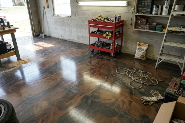 High-gloss metallic epoxy garage floor with swirled bronze and charcoal pigment