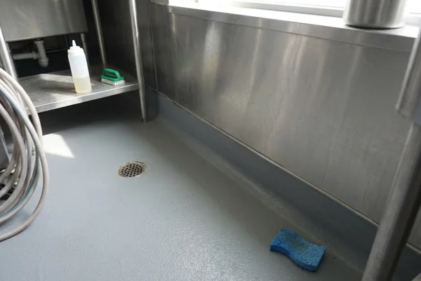 Integral hygienic cove base carrying the floor coating up the wall