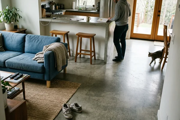 Matte honed polished concrete floor in an open-plan kitchen and living area