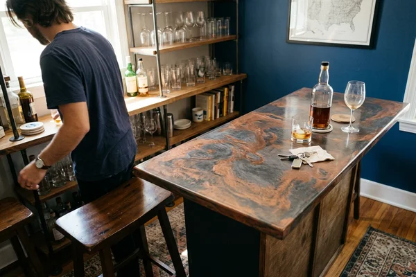 Metallic epoxy bar countertop with swirled copper and charcoal pigment