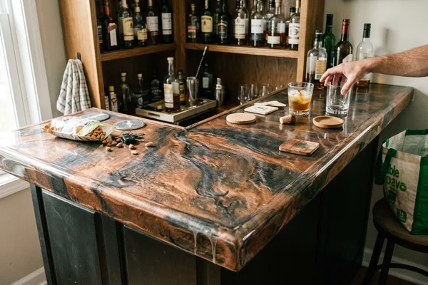 Metallic epoxy bar top with swirled copper and charcoal pigment