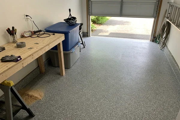 The same garage finished with a seamless gray flake epoxy floor