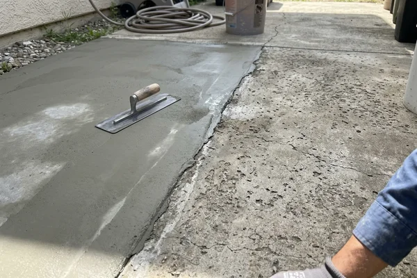 Repaired and resurfaced concrete beside the original spalled slab